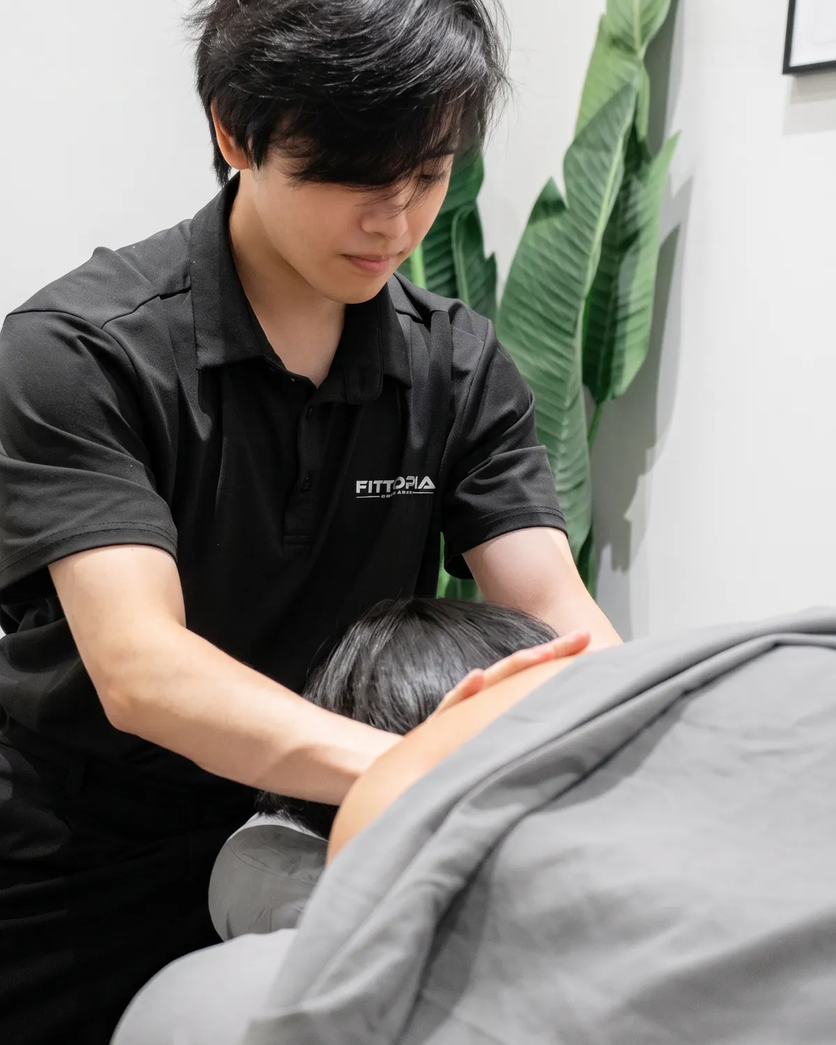 Registered massage therapist treating a patient's neck and shoulders